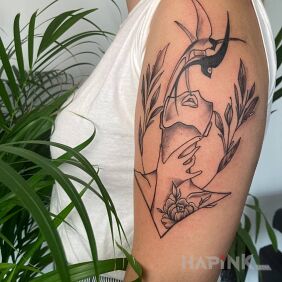 Tattoo Swallow tattoo on the upper arm motif: faces style: graphic / illustrative