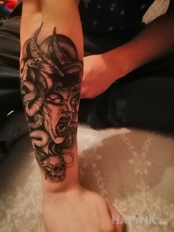 Tattoo Meduza ✌️ in black and gray motif and graphic / illustrative style On the arm