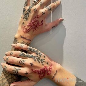 Tattoo Snake and scorpion in red on the hand motif: black and gray style: graphic / illustrative