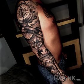 Tattoo Compass with chain on the upper arm motif: black and gray style: realistic