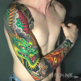 Tattoo Green dragon on the upper arm motif: colorful style: japanese / irezumi