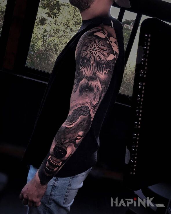 Tattoo Dziad i jego wilk in faces motif and realistic style on the upper arm