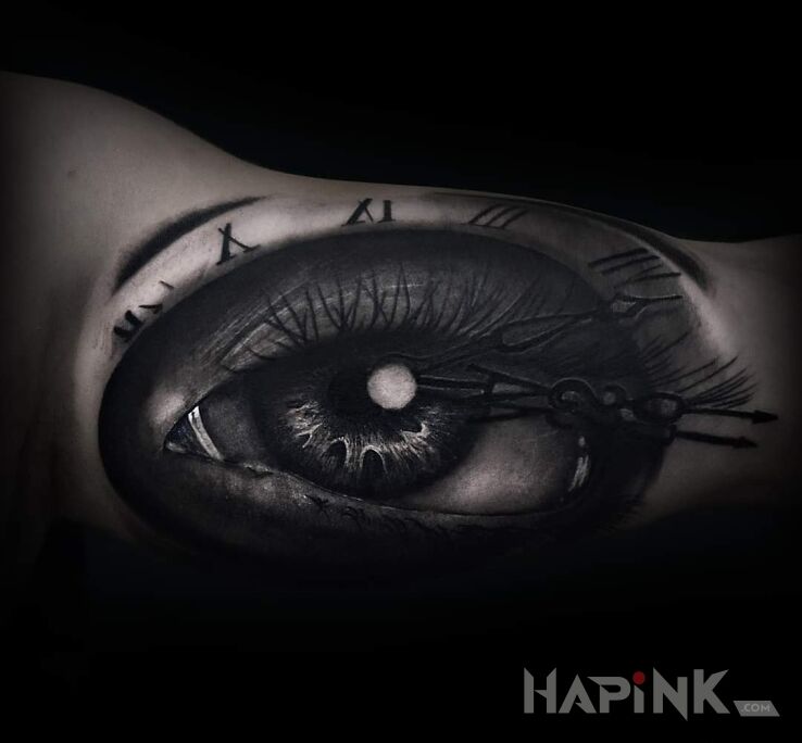 Tattoo Oko in black and gray motif and realistic style On the arm
