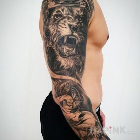 Tattoo Big lion On the arm motif: butterflies style: realistic