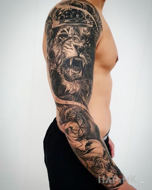Tattoo Big lew in butterflies motif and realistic style On the arm