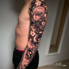 Tattoo Bird with flowers around on the upper arm motif: animals style: realistic