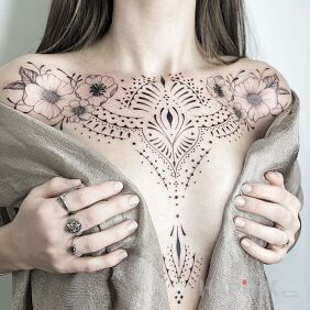 Tattoo Tattooed front between the breasts motif: ornaments style: graphic / illustrative