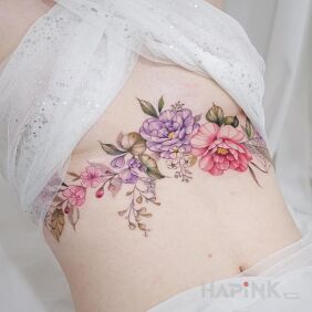 Tattoo Colorful flowers flowers on the stomach motif: floral style: realistic