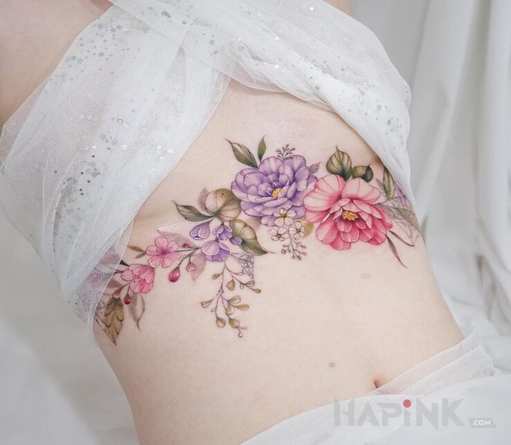 Tattoo Kwiatki kolorowe kwiatki in flowers motif and realistic style on the ribs