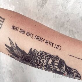 Tattoo Vibe on the forearm motif: lettering