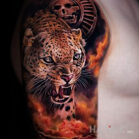 Tattoo Fierce jaguar on the upper arm motif: colorful style: realistic