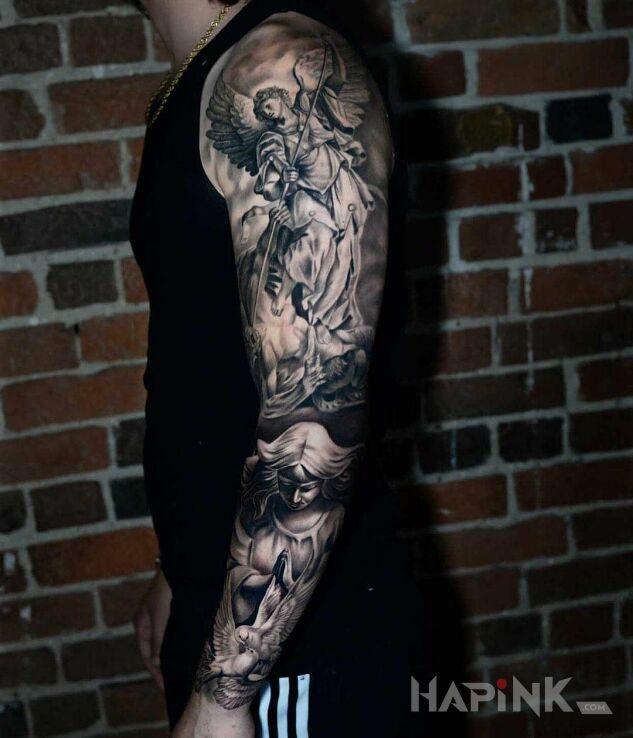 Tattoo Archanioł Gabriel in religious motif and realistic style on the upper arm