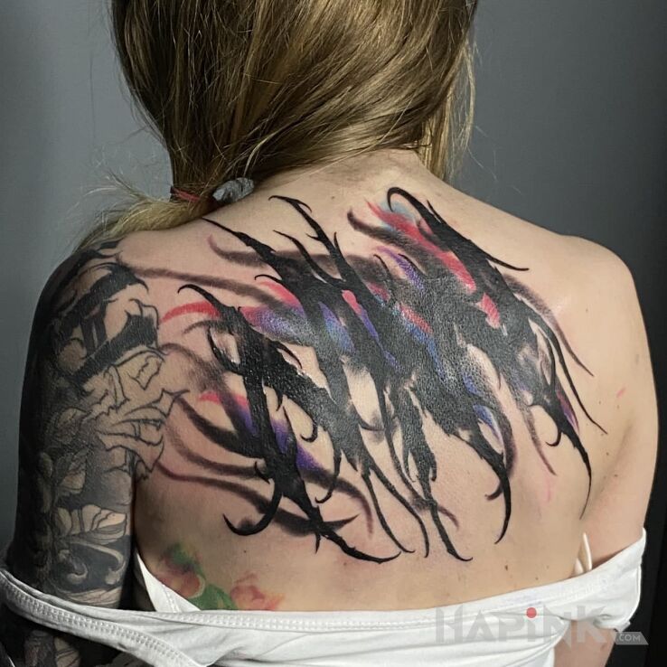 Tattoo DARK LETTERING in black and gray motif and blackwork / blackout style on the back