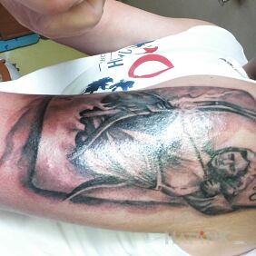 Tattoo STRZELEC on the upper arm motif: zodiac signs
