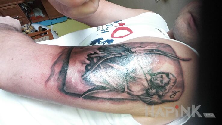 Tattoo STRZELEC in zodiac signs motif on the upper arm