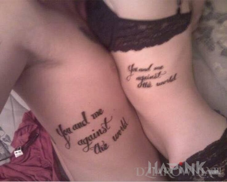 Tattoo You and me against the world in lettering motif on the ribs