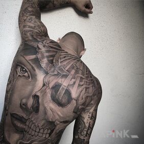 Tattoo Life and death on the upper arm motif: skulls style: realistic