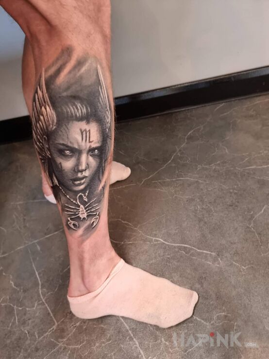 Tattoo Valkiria with Scorpio in faces motif and realistic style on the calf