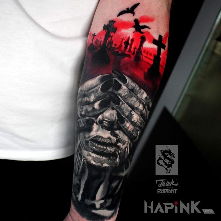 Tattoo Cmentarz in faces motif and realistic style On the arm