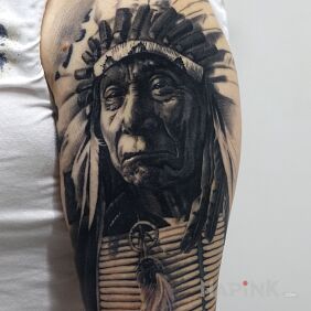 Tattoo Indian on the upper arm motif: black and gray style: realistic