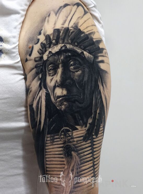 Tattoo Indianin in black and gray motif and realistic style on the upper arm