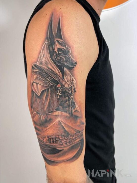 Tattoo Anubis Piramida in characters motif and realistic style on the upper arm