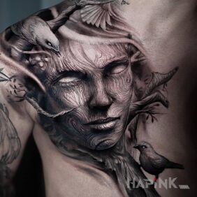 Tattoo Wooden face on the shoulder blades motif: black and gray style: realistic