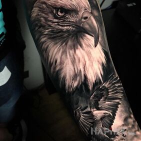 Tattoo Proud eagle On the arm motif: black and gray style: realistic