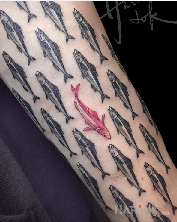Tattoo Ryba, która płynie pod prąd in black and gray motif and realistic style on the forearm