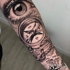 Tattoo Eye on the compass On the arm motif: black and gray style: realistic