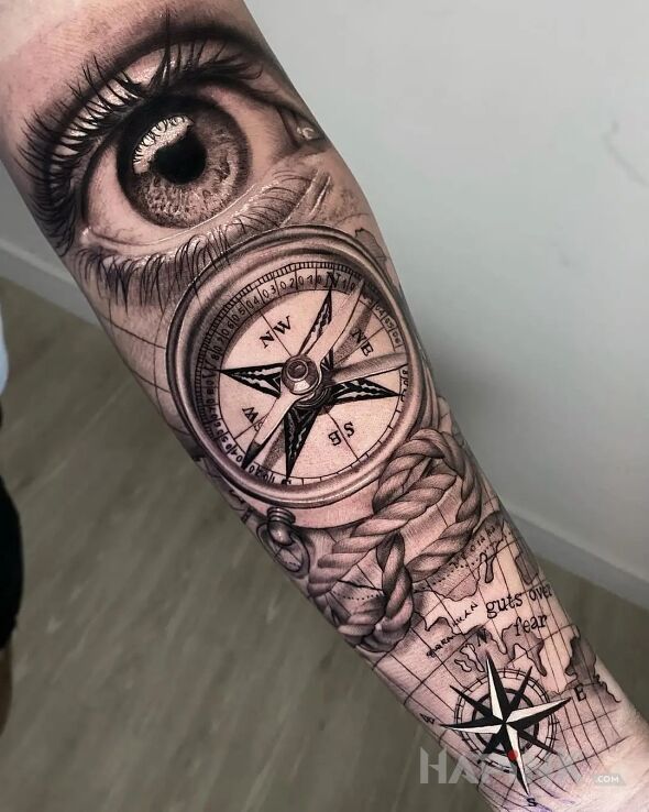 Tattoo Oko na kompas in objects motif and realistic style On the arm
