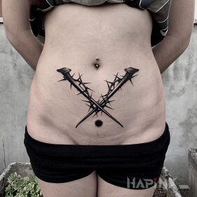 Tattoo Two nails on the stomach motif: objects style: graphic / illustrative