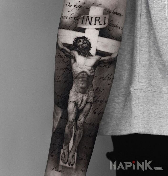 Tattoo Ukrzyżowany Jezus in religious motif and realistic style on the forearm