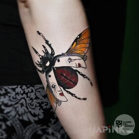 Tattoo Beetle On the arm motif: faces style: graphic / illustrative