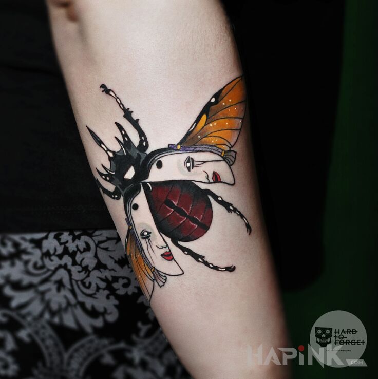 Tattoo Żuk in faces motif and graphic / illustrative style on the forearm