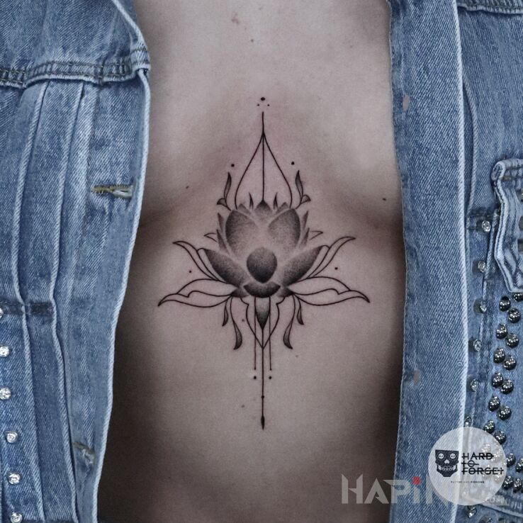 Tattoo Lotos in black and gray motif and dotwork style on the stomach