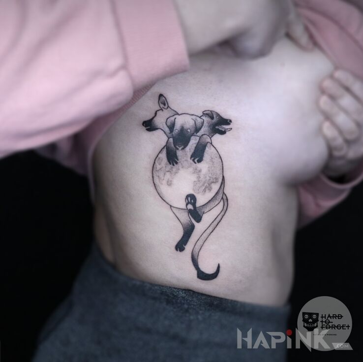 Tattoo Baby Cerber in black and gray motif and graphic / illustrative style on the ribs