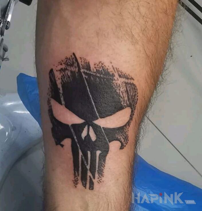 Tattoo Punisher in black and gray motif and graphic / illustrative style On the arm