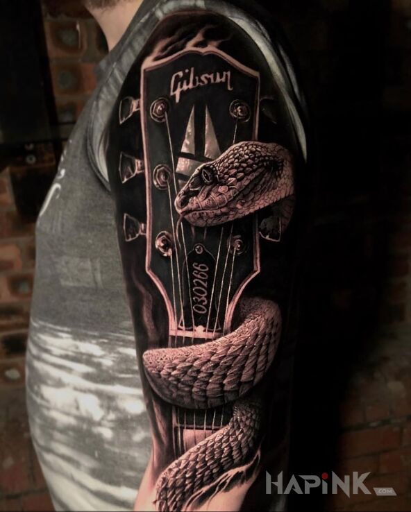 Tattoo Gitara gibson in 3D motif and realistic style on the upper arm