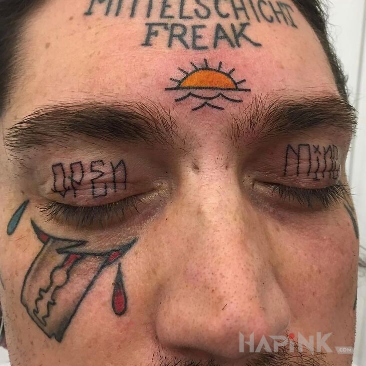 Tattoo Otwarta glowa in lettering motif on the face