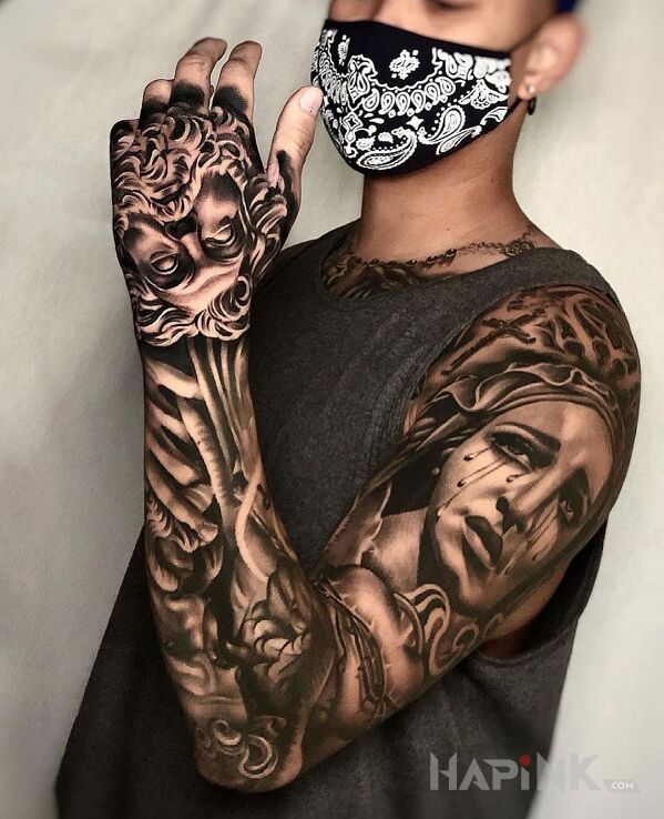 Tattoo Płacząca Maryja in religious motif and realistic style on the upper arm