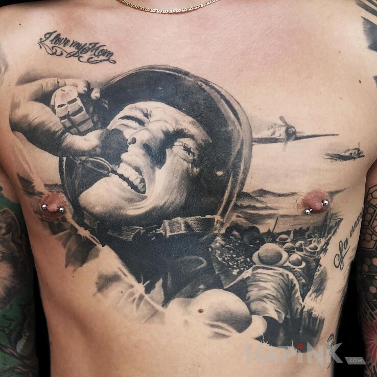Tattoo Rzut granatem in black and gray motif and realistic style on the chest
