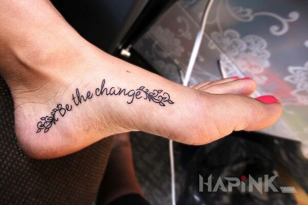 Tattoo Be the change in lettering motif on the foot