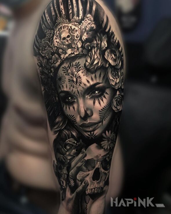 Tattoo Szamanka in faces motif and realistic style On the arm