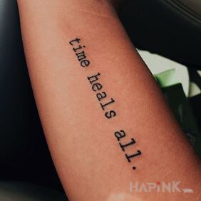 Tattoo Time heals wounds. on the bicep motif: lettering
