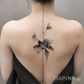 Tattoo Flower on a straight line on the back motif: black and gray style: graphic / illustrative