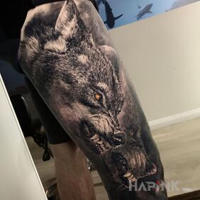 Tattoo Wolfhounds on the attack on the leg motif: black and gray style: realistic