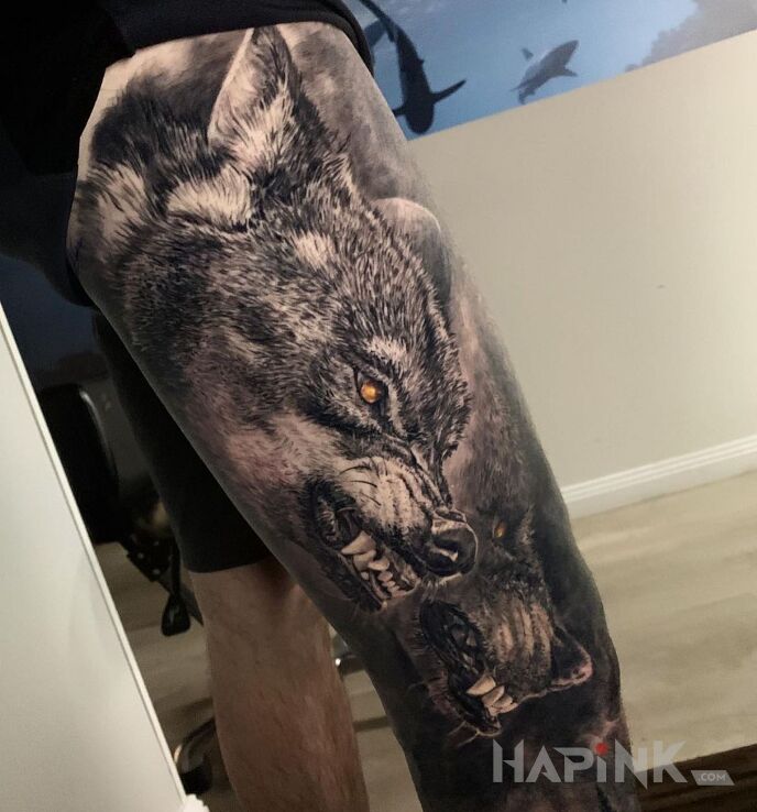 Tattoo Wilczury w natarciu in black and gray motif and realistic style on the leg