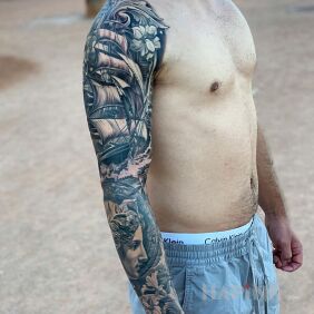 Tattoo Ship against the sea waves on the forearm motif: sleeves style: realistic
