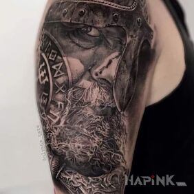 Tattoo Viking on the upper arm motif: black and gray style: realistic